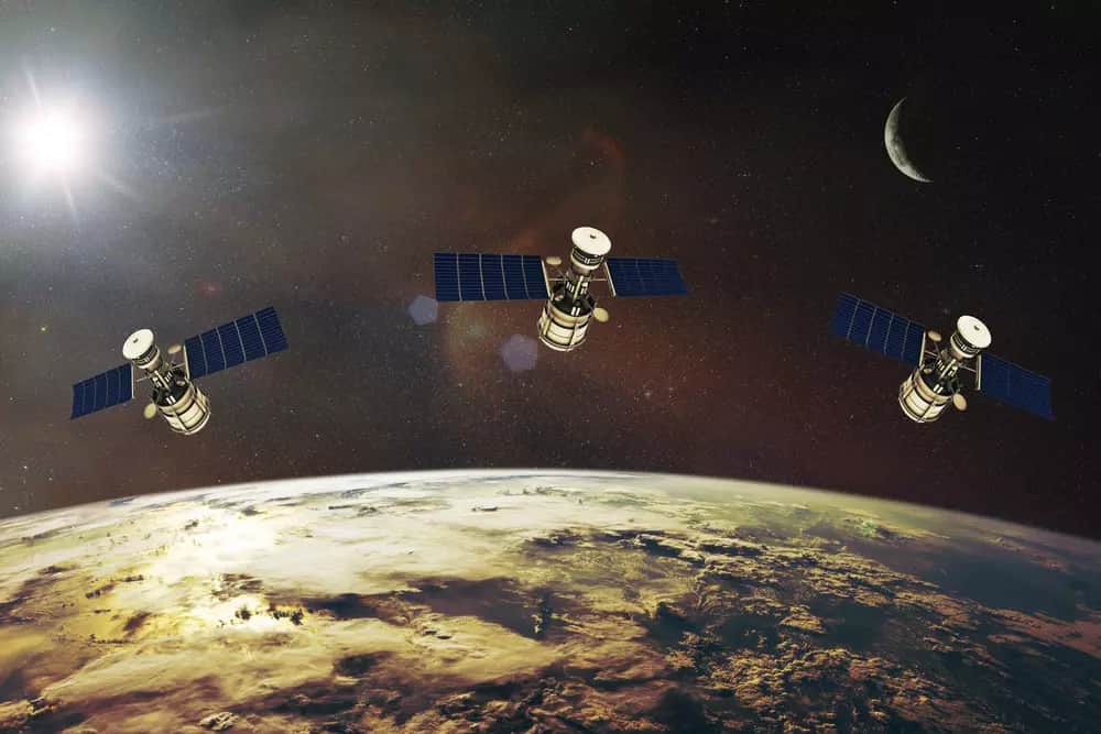 Satélites LEO orbitando a Terra, representando a parceria entre satélites de baixa órbita e fibra óptica para promover inclusão digital.